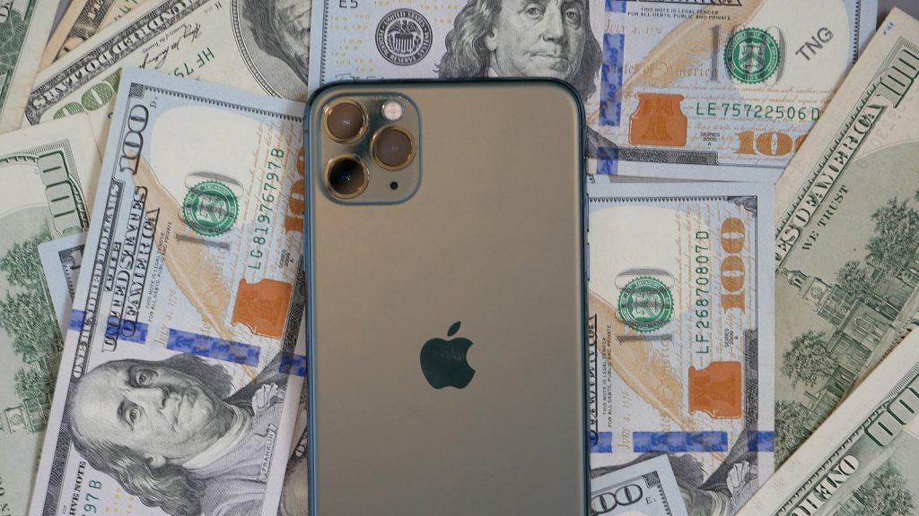 iPhone 12 with dollar bills