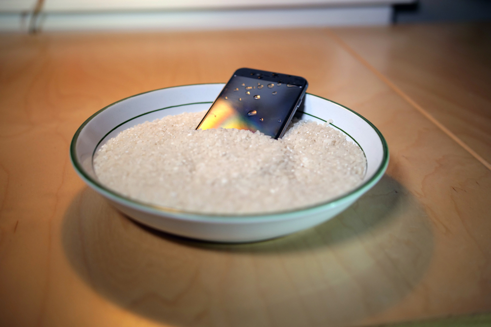 a cellphone in a bowl of rice